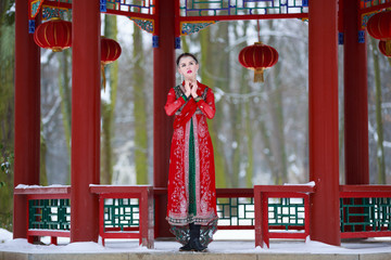 Woman in oriental dress in a winter park