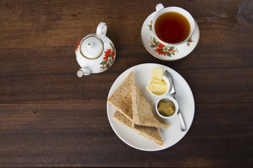 Slices of toast bread with butter on wooden table