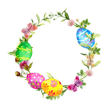 Easter wreath with colored eggs in grass, flowers. Round frame. Watercolor