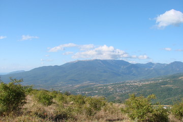 a view of the Crimean mountain range and an inhabited valley at its foot.