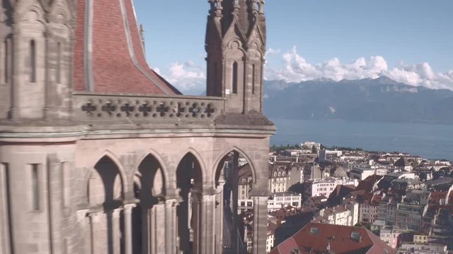Lausanne Cathedral cinematic drone shot. Camera flying over the city and revealing the beautiful cathedral