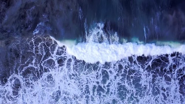 4K Cinematic sea wave breaking with perfect timing. Ocean surf on a dark blue water - scenic nature in motion