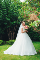 Fototapeta na wymiar Happy bride with bouquet