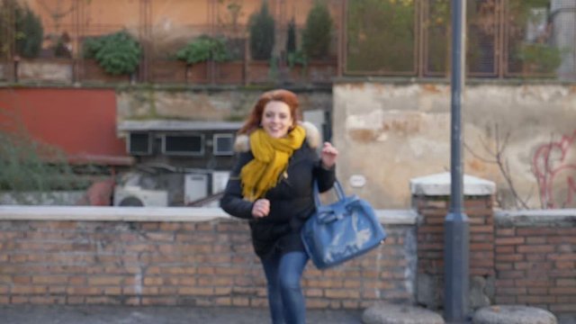 Happy beautiful woman running towards the camera- slow motion
