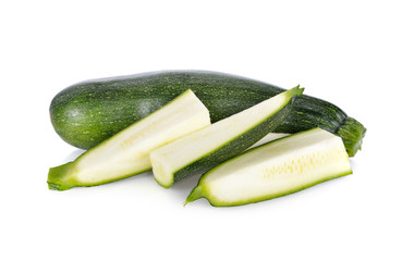 whole and sliced fresh zucchini on white background