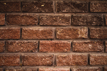 Textured background of antique decorative brick with easy vignetting. Medieval background for a brick wall