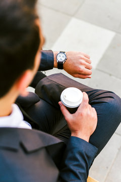 Young businessman take break to drink coffee outdoor