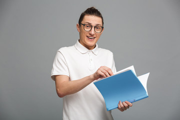 Cheerful young man holding folder.