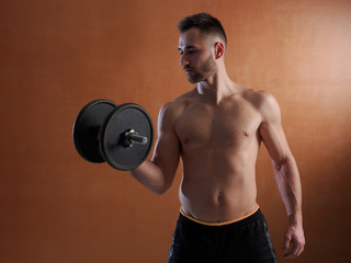 Obraz na płótnie Canvas Young man training with weight lifting.