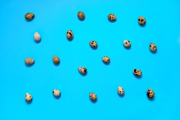 Quail eggs on blue background, copy space. Healthy food concept. Top view, flat lay. Easter eggs. Happy Easter concept