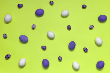 Chicken eggs and quail eggs on green background, copy space. Healthy food concept. Top view, flat lay. Easter eggs. Happy Easter concept