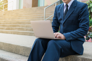 Businessman use computer outdoor