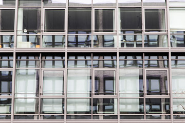 facade building with windows at daylight with reflections