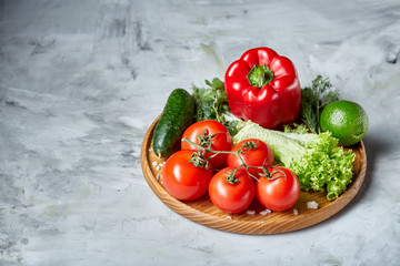 Delicious composition of assorted fresh vegetables and herbs on white textured background, top view, selective focus.