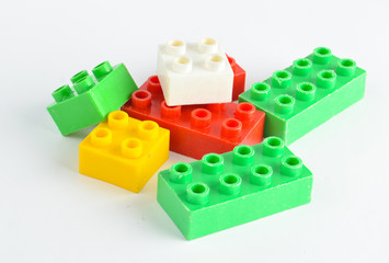 Colorful toy bricks of a children's designer on a white background..