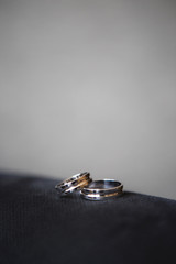 Two wedding rings of white gold on a black background