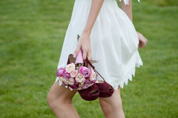Wedding shoes and a bridal bouquet.  Short wedding dress