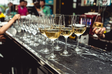 row of white wine glasses. bar in the expensive restaurant