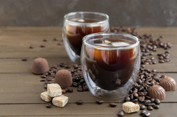 Coffee in double-walled glass on a wooden table.
