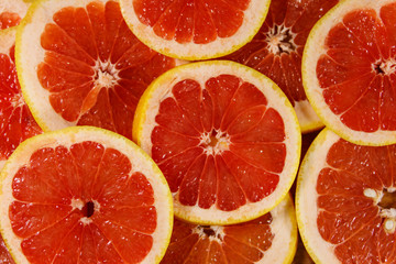 Fresh slices of grapefruits as background
