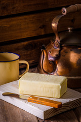 block of fresh butter, kettle, knife and Cup