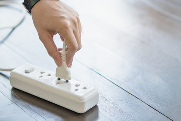person unplug electrical device 