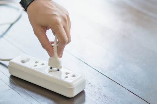 person unplug electrical device 