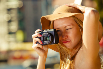 Beautiful elegant woman taking pictures with camera