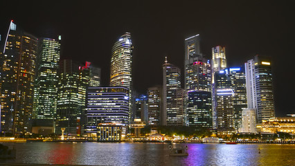 Fototapeta na wymiar Stunning view of the Singapore city skyline at night time from the Marina Bay