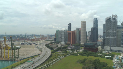 AERIAL: Flying over construction site and towards empty city harbor terminals.