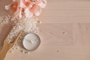 Spa concept. White bath salt on the whit wooden background 