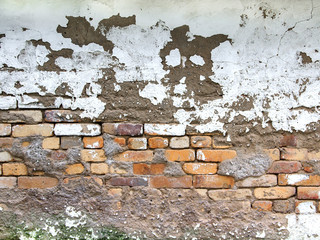 The texture of the old brick wall with concrete seams