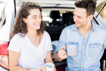 Couple enjoying a coffee break on car trip