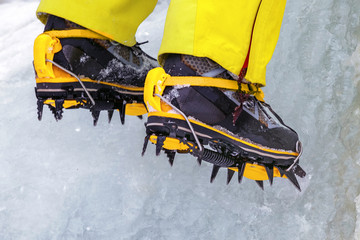 Crampons close-up on his feet ice climber, climber on a frozen waterfall
