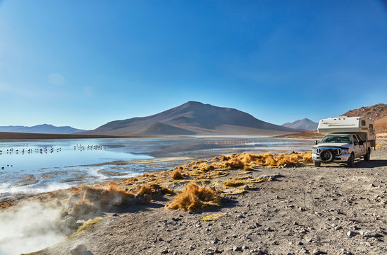 Recreational vehicle moving across landscape, Chalviri, Oruro, Bolivia, South America