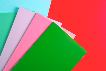Colorful notebooks on blue and red background