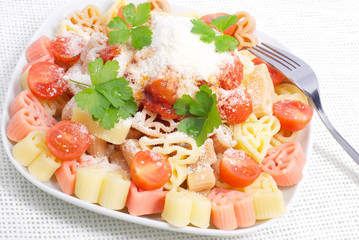Colorful pasta with tomato sauce and cheese