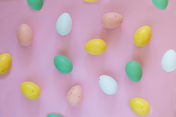 Colorful easter eggs on pink background, easter symbols