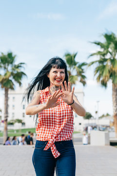 Mature female hipster walking in park, portrait, Valencia, Spain