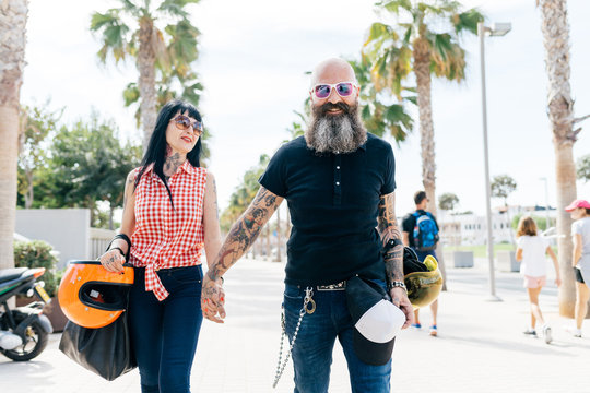 Portrait of mature hipster couple strolling on sidewalk, Valencia, Spain
