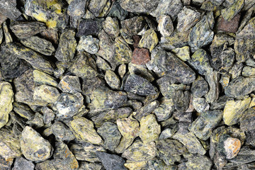 small gray-green stones of heterogeneous structure, background