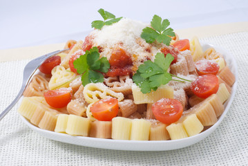 Colorful pasta with tomato sauce and cheese