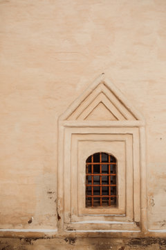 Old yellow wall with closed window