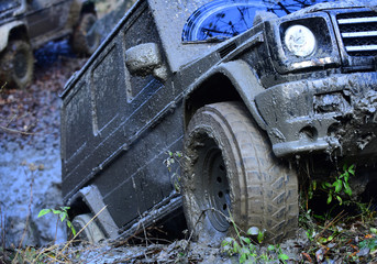 Wheel of dirty offroad car covered with mud