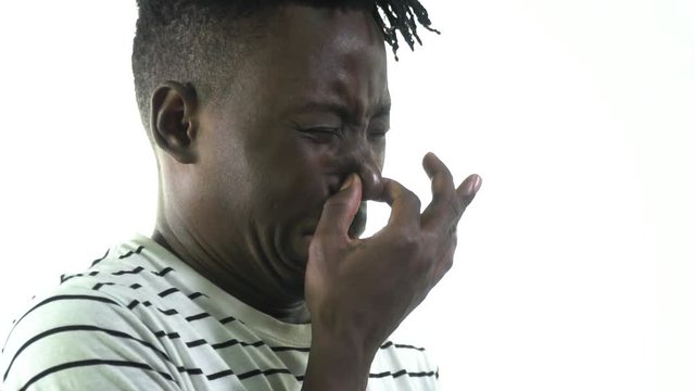 The black man grimaced at the stench