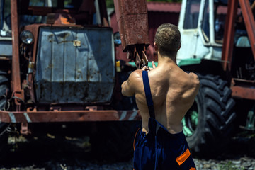 Obraz na płótnie Canvas Man, builder or bodybuilder with in overalls working.