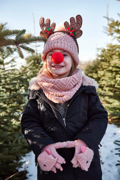 Girl In Christmas Tree Forest With Red Nose, Portrait