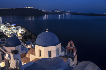 Greek Orthodox Church of St. Nicholas against the backdrop of the Aegean Sea in Oia on the island of Santorini in Greece