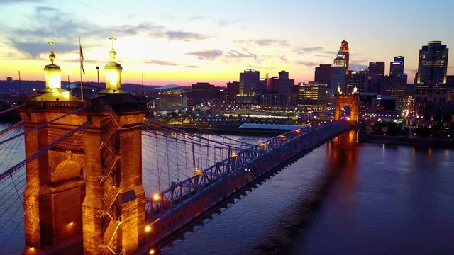A beautiful evening aerial shot of Cincinnati Ohio with bridge crossing the Ohio River foreground.