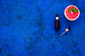 Homemade spa with grapefruit oil in natural cosmetic set fruit blue background top view mock up